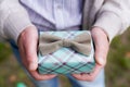 Male Gift box in man`s hand with gray bow Royalty Free Stock Photo