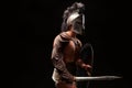 Gladiator with sword and armor on a black background Royalty Free Stock Photo