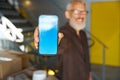 Male in glasses with mobile phone in a warehouse Royalty Free Stock Photo