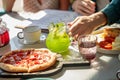 Male is going to pour sweet beverage into glasses for woman