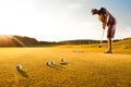 Male golf player practicing a par during sunset Royalty Free Stock Photo