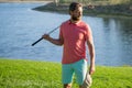 Male golf player on professional golf course. Portrait of golfer man with golf club. Royalty Free Stock Photo