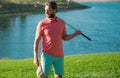 Male golf player on professional golf course. Portrait of golfer man with golf club. Royalty Free Stock Photo