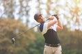 Male golf player on professional golf course. Taking a shot Royalty Free Stock Photo