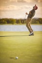 Male golf player shot past hole. Royalty Free Stock Photo