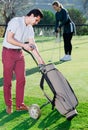 Male golfer examining clubs Royalty Free Stock Photo