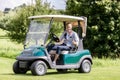 Male golfer in golf cart showing thumbup sign Royalty Free Stock Photo