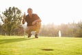 Male Golfer Lining Up Putt On Green Royalty Free Stock Photo