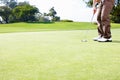 Male golfer putting the ball. Low section of golfer in position to putt the ball. Royalty Free Stock Photo