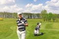 Male golfer standing at fairway on golf course Royalty Free Stock Photo