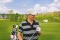 Male golfer standing at fairway on golf course Royalty Free Stock Photo