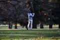 Male Golfer After Swing On Golf Course Amid Trees