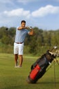 Male golfer swinging golf club
