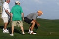 Male golfers on putting green.