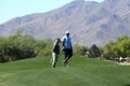 Male golfers on putting green.