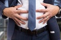 Male grabbing bloated abdomen as indigestion problem Royalty Free Stock Photo