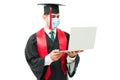 Male graduate attending his online graduation with a laptop Royalty Free Stock Photo