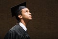 Male graduate looking up