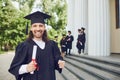 Male graduate is smiling against the background of university graduates. Royalty Free Stock Photo