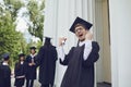 Male graduate is smiling against the background of university graduates. Royalty Free Stock Photo