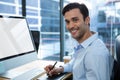 Male graphic designer using graphics tablet at desk