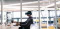 Male graphic designer using virtual reality headset while working on computer at desk Royalty Free Stock Photo