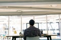 Male graphic designer working on computer at desk in a modern office Royalty Free Stock Photo