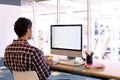 Male graphic designer working on computer at desk in a modern office Royalty Free Stock Photo