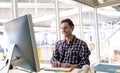 Male graphic designer working on computer at desk in a modern office Royalty Free Stock Photo