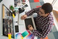 Male graphic designer working on computer at desk in office Royalty Free Stock Photo