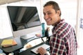 Male graphic designer working on computer at desk in office Royalty Free Stock Photo