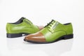 Male green leather elegant shoes on white background. Royalty Free Stock Photo