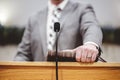 Male in a grey suit preaching words of the Holy Bible at the altar of a church Royalty Free Stock Photo