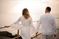 Male groom and female bride walking on the bridge holding hands Royalty Free Stock Photo