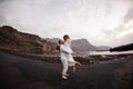 Male groom holding on hands female bride on the beach Royalty Free Stock Photo