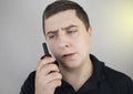 A male guard talking on a walkie talkie with his partner. A policeman takes up the challenge of public safety. Safety and Security Royalty Free Stock Photo
