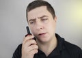 A male guard talking on a walkie talkie with his partner. A policeman takes up the challenge of public safety. Safety and Security