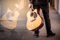 Male guitarist holding acoustic guitar