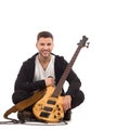 Male guitarist sitting on the floor. Royalty Free Stock Photo