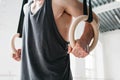 Male gymnast doing workout on gymnastics rings in cross gym Royalty Free Stock Photo