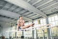 Male gymnast performing handstand on parallel bars