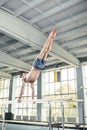 Male gymnast performing handstand on parallel bars