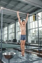 Male gymnast performing handstand on parallel bars