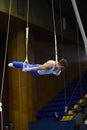 Male gymnast performing on stationary gymnastic rings Royalty Free Stock Photo