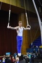 Male gymnast performing on stationary gymnastic rings Royalty Free Stock Photo