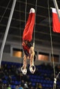 Male gymnast performing on stationary gymnastic rings Royalty Free Stock Photo