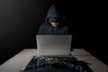 Male Hacker behind laptop computer, cyber attack concept Royalty Free Stock Photo