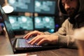 Male hacker using security breach to hack server Royalty Free Stock Photo