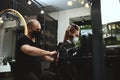 A hairdresser concentrated on combing hair of beauty salon customer for furthers cutting Royalty Free Stock Photo