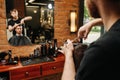 Working hairdresser making a haircut for a young man in a barber shop Royalty Free Stock Photo